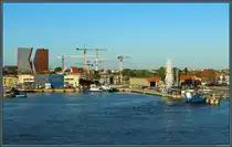 An der M�ndung des Dange in das Memelhaff entsteht ein neues Stadtviertel unweit der Altstadt von Klaipėda. Im Vordergrund rechts neben dem Riesenrad startet die Personenf�hre zur Kurischen Nehrung. Links sind hingegen noch alte Hafenanlagen zu sehen. (Klaipėda, 24.08.2024)