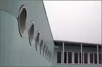 . Das Lehrerzimmer mit seinen Bullaugen wirkt wie eine Kommandobr�cke. Die Assoziation mit Augen wird bei ausgefahrenem Sonnenschutz noch verst�rkt, die blauen gerundeten Markisen wirken wie Augenlider. 05.03.2011 (Matthias)