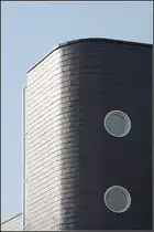 . Heinrich-Fries-Haus Heilbronn: Der auf einer seite abgerundete Treppenhausturm mit seinen Bullaugen. Die Geb�ude wurde mit dunklen Naturschieferplatten verkleidet. 09.03.2011 (Matthias)