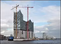 . Gro� und teuer - die neue Elbphilharmonie in Hamburg. Neben dem Konzertsaal entstehen hier auch Wohnungen und ein Hotel. Hinter den Mauern des alten Speichergeb�ude befindet sich das Parkhaus. Architekten: Herzog und de Meuron (Basel). Im Hintergrund rechts der Marco-Polo-Wohnturm und das neue Unilever-Geb�ude, beide von Behnisch Architekten (Stuttgart). August 2011 (Jonas)